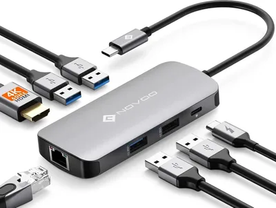 A silver USB-C hub with multiple ports and cables is displayed on a white background.