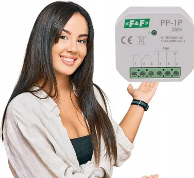 A woman is presenting a small electronic device.