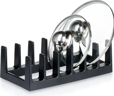 A black pot lid rack holding two glass pot lids.