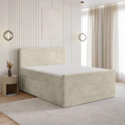 A bedroom scene with a bed, nightstand, and artwork on the wall.