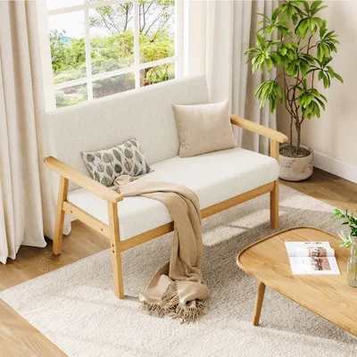 A cozy living room scene with a sofa, coffee table, and plant.