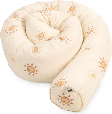 A coiled up baby bed guard with a sun pattern.
