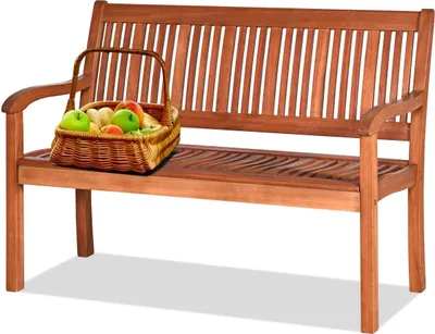 A wooden garden bench with a basket of fruit on it, set against a white background.