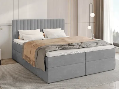 A bed with bedding in a room.