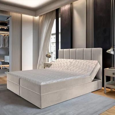 A bedroom scene featuring a boxspring bed.
