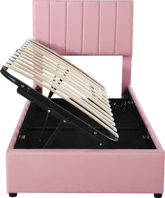 A pink upholstered bed frame with the slatted base lifted to reveal storage space underneath.