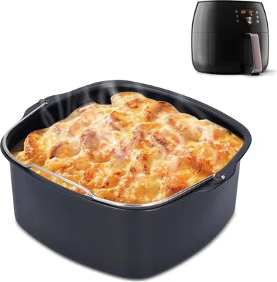 A close-up of a baking dish filled with food, placed in front of an air fryer.