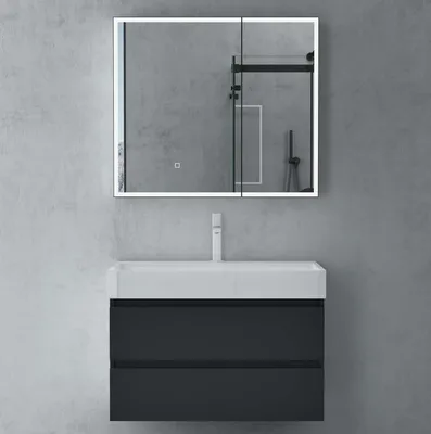 A modern bathroom vanity with a mirror cabinet and faucet against a concrete wall.
