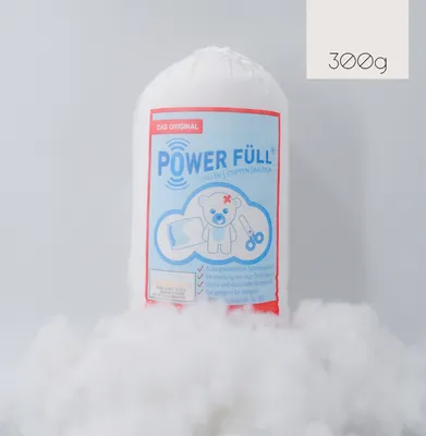 A bag of white filling material is shown in the center of the image, surrounded by loose filling material.