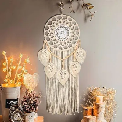 Immagine prodotto di Decorazione da parete in stile boho con foglie e nappe per creare un'atmosfera accogliente