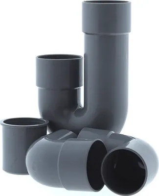 A collection of grey PVC plumbing fittings, including a P-trap and several elbows, arranged on a white background.