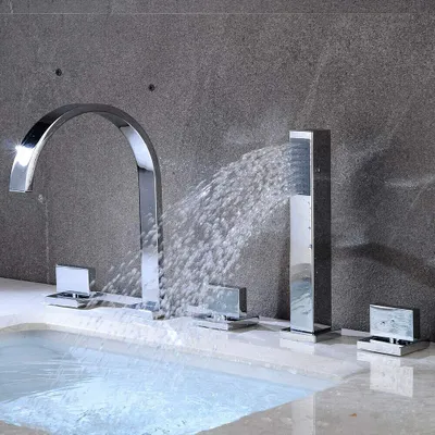 A modern bathroom faucet with water flowing into a bathtub.