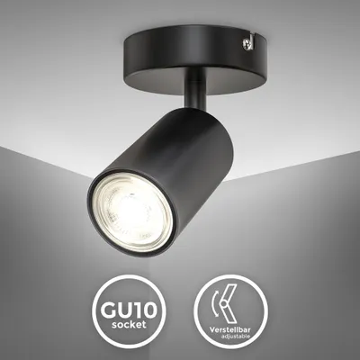 A black adjustable spotlight mounted on a white ceiling, with informational badges below.