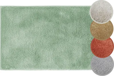 A green bath mat with swatches of other colors on the right.