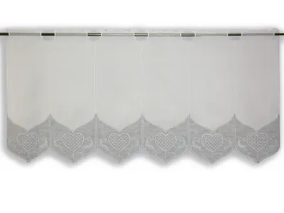 A white sheer curtain with a grey heart pattern along the bottom edge, hanging from a curtain rod.