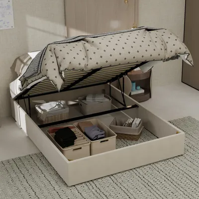 A bed frame with its storage compartment open, showing various storage bins and folded items inside.
