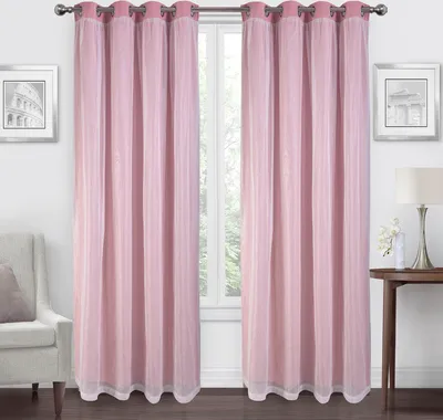 A room interior with pink curtains covering a window, a chair, and a table with a lamp.