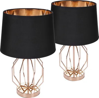 Two modern table lamps with black shades and gold geometric bases are shown against a white background.