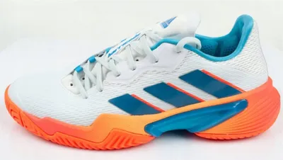 A side view of a single Adidas Barricade tennis shoe.
