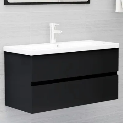 A black bathroom vanity with a white sink and faucet against a tiled wall.