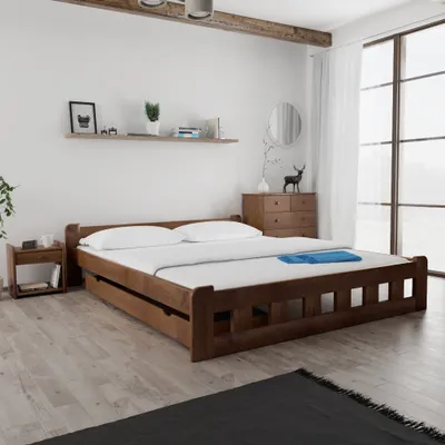 A bedroom scene with a wooden bed frame and nightstand.
