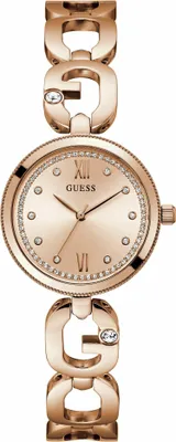 A close-up studio shot of a rose gold Guess watch with a diamond-accented bracelet and bezel.