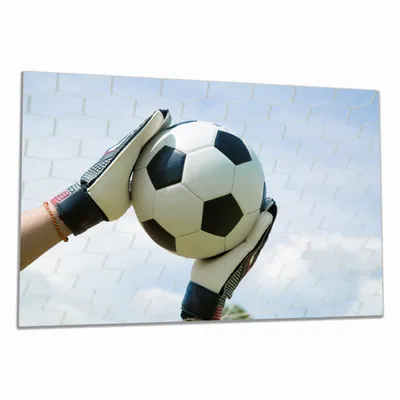 Produktbild von Wallario Herdabdeckplatte aus Glas, Größe 80 x 52 cm 1-teilig, Motiv Fußball - Torwart im Tor vor blauem Himmel
