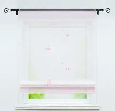 A sheer pink and white Roman blind with a butterfly pattern is shown hanging in a window.