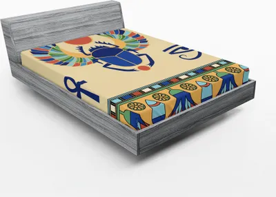 A fitted sheet with an Egyptian-themed print is displayed on a bed frame.