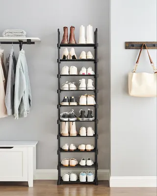 An entryway or hallway with a shoe rack, hanging clothes, and a chest of drawers.