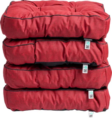 A stack of four red cushions on a white background.