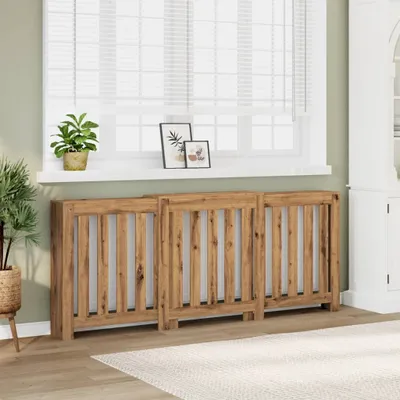 Three wooden radiator covers are placed in front of a window with blinds. A potted plant sits on the windowsill.