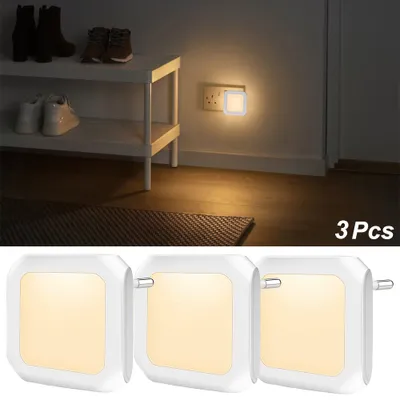 A shoe rack with shoes and a night light plugged into a wall socket.