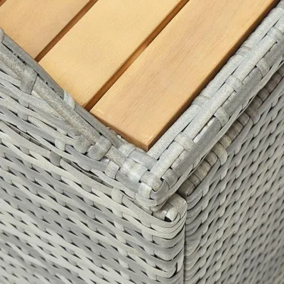 Close-up of the corner of a wicker storage bench with wooden slats.