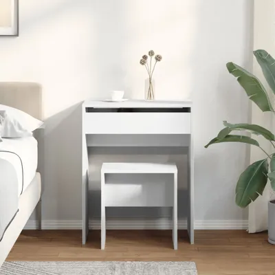 A white vanity table and stool set in a bedroom setting.