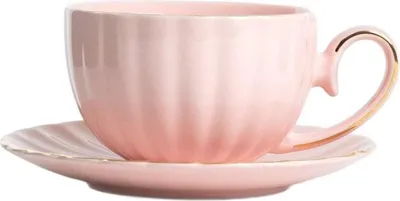 A pink teacup and saucer set.