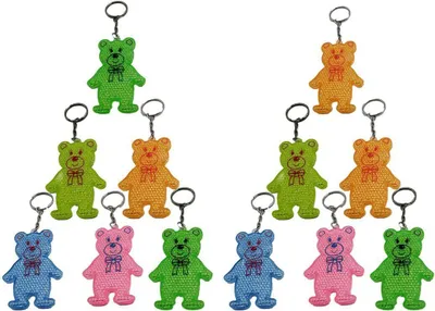 Produktbild von 12 x Reflektor Bär Schlüsselanhänger Kunststoff reflektierend Sicherheit 7 cm