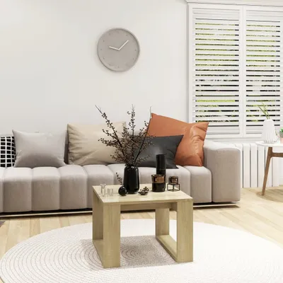 A living room scene with a sofa, coffee table, and decorative items.