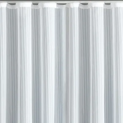 A close-up view of a white, semi-transparent curtain with vertical pleats.