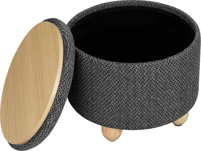 A round storage ottoman with a wooden lid is shown with the lid open.