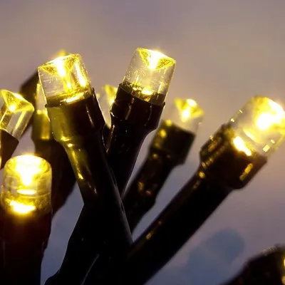 A close-up shot of multiple yellow LED lights on dark wires.
