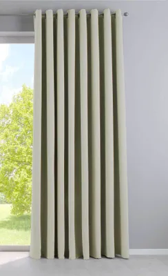 A beige curtain hangs in front of a window with a tree outside.