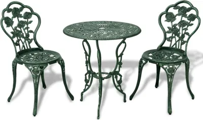 A green metal bistro set with a round table and two chairs, decorated with rose motifs, is displayed against a white background.