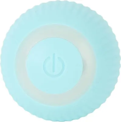 A top-down view of a light blue interactive ball for pets, featuring a power button symbol in the center.