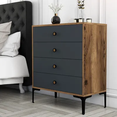 A bedroom scene with a dresser next to a bed.