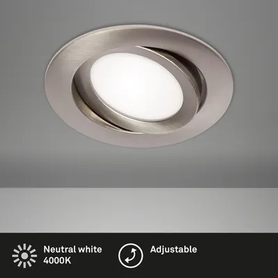 A close-up shot of a recessed ceiling light fixture with a brushed nickel finish, mounted on a gray ceiling.