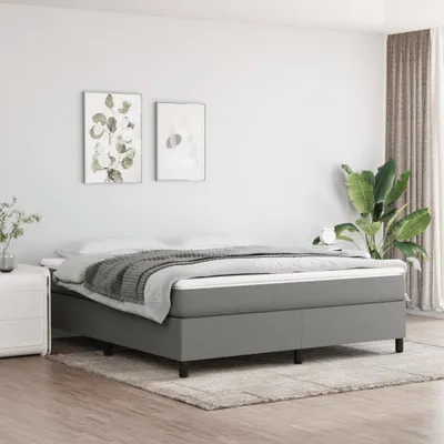 A bedroom scene with a bed, nightstand, and artwork on the wall.
