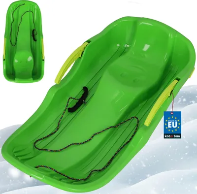A green plastic sled with yellow handles and a rope, shown on a snowy background.