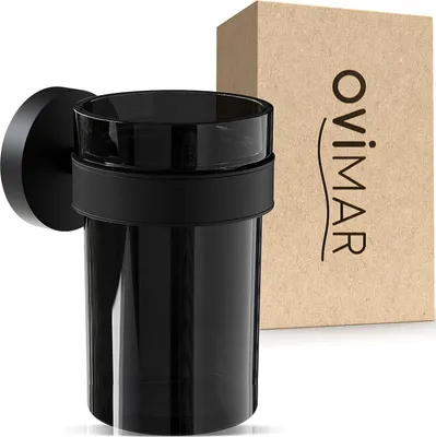 A black glass toothbrush holder with a black metal mount is shown next to its packaging.