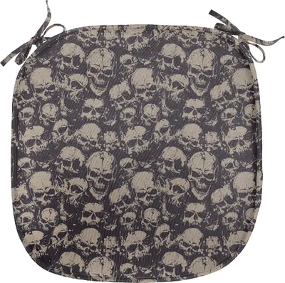 A square seat cushion with ties, patterned with many skulls.